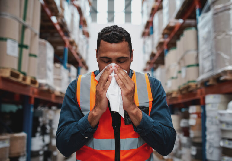 worker blowing nose